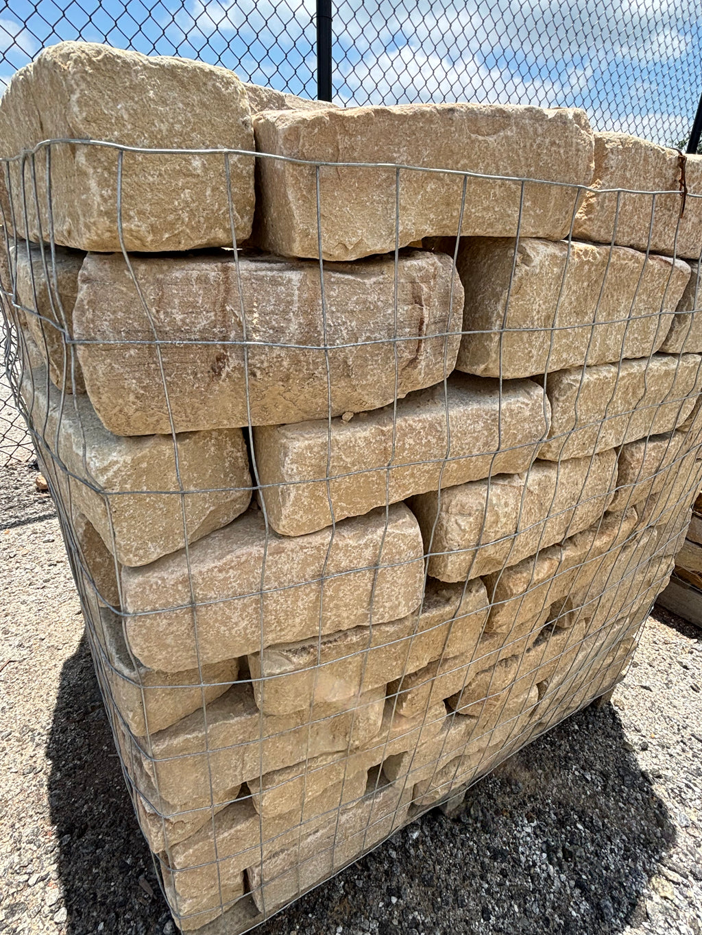 Brown tumbled cobble stacked on a pallet at 9 Oak in Jenkinsburg Georgia