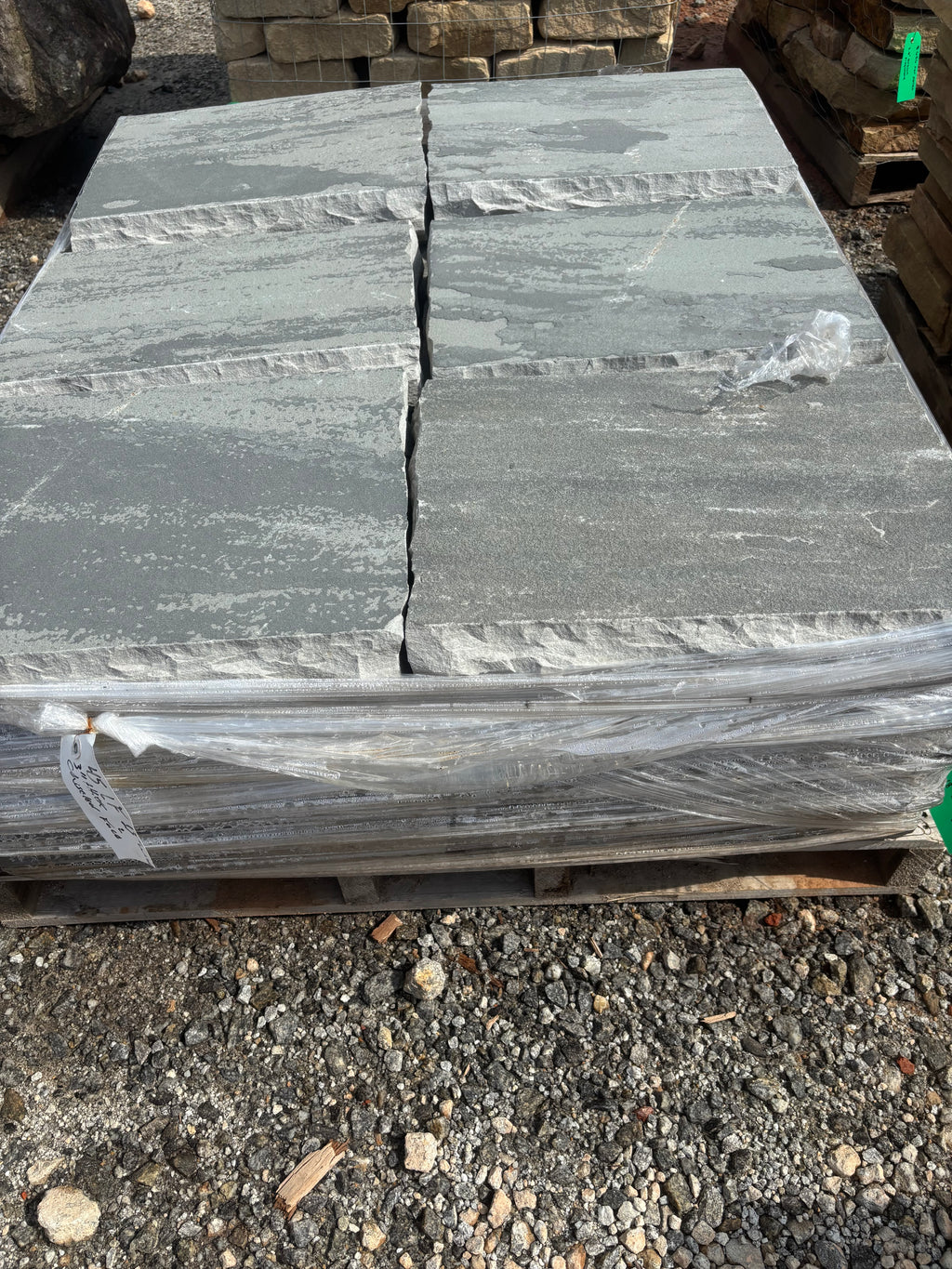Gray 18 by 24 chiseled stone steppers stacked at 9 Oak in Jenkinsburg Georgia