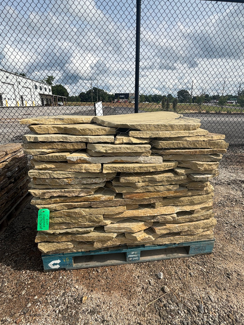 Tan and brown 1.5 inch flagstone stacked on a pallet at 9 Oak in Jenkinsburg Georgia