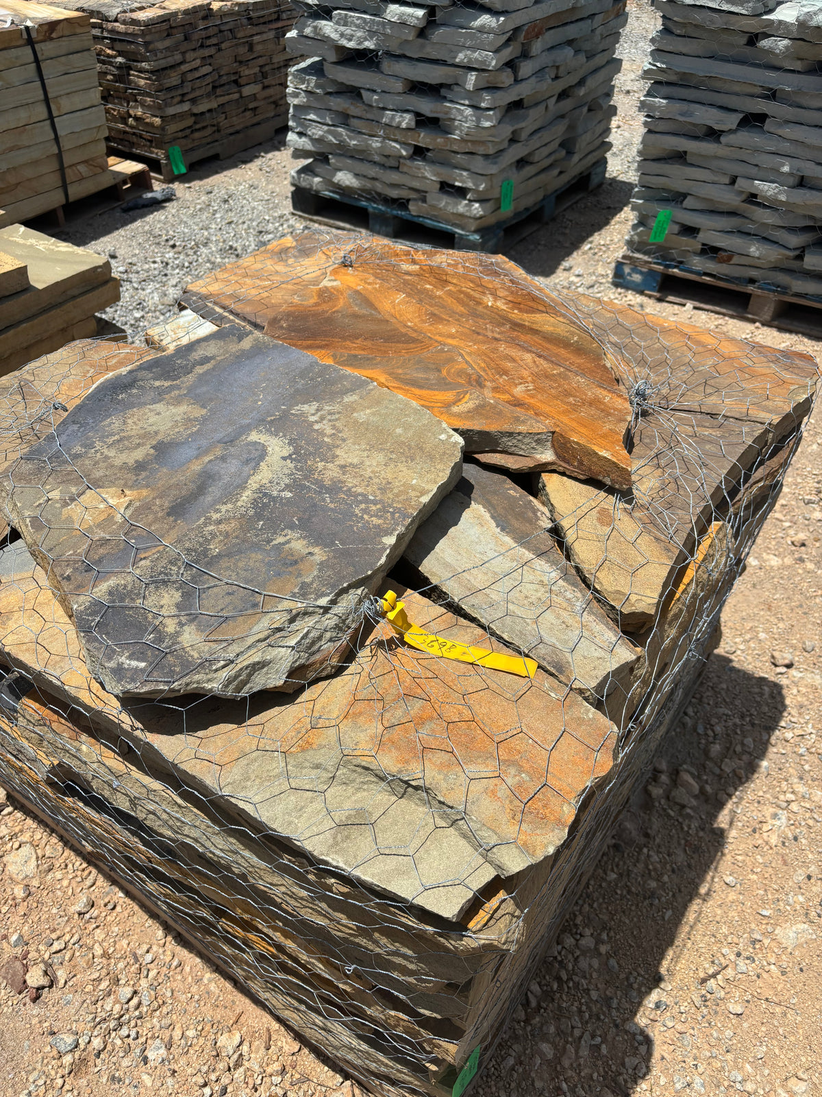 2.5 inch brown flagstone stacked on a pallet at 9 Oak in Jenkinsburg Georgia