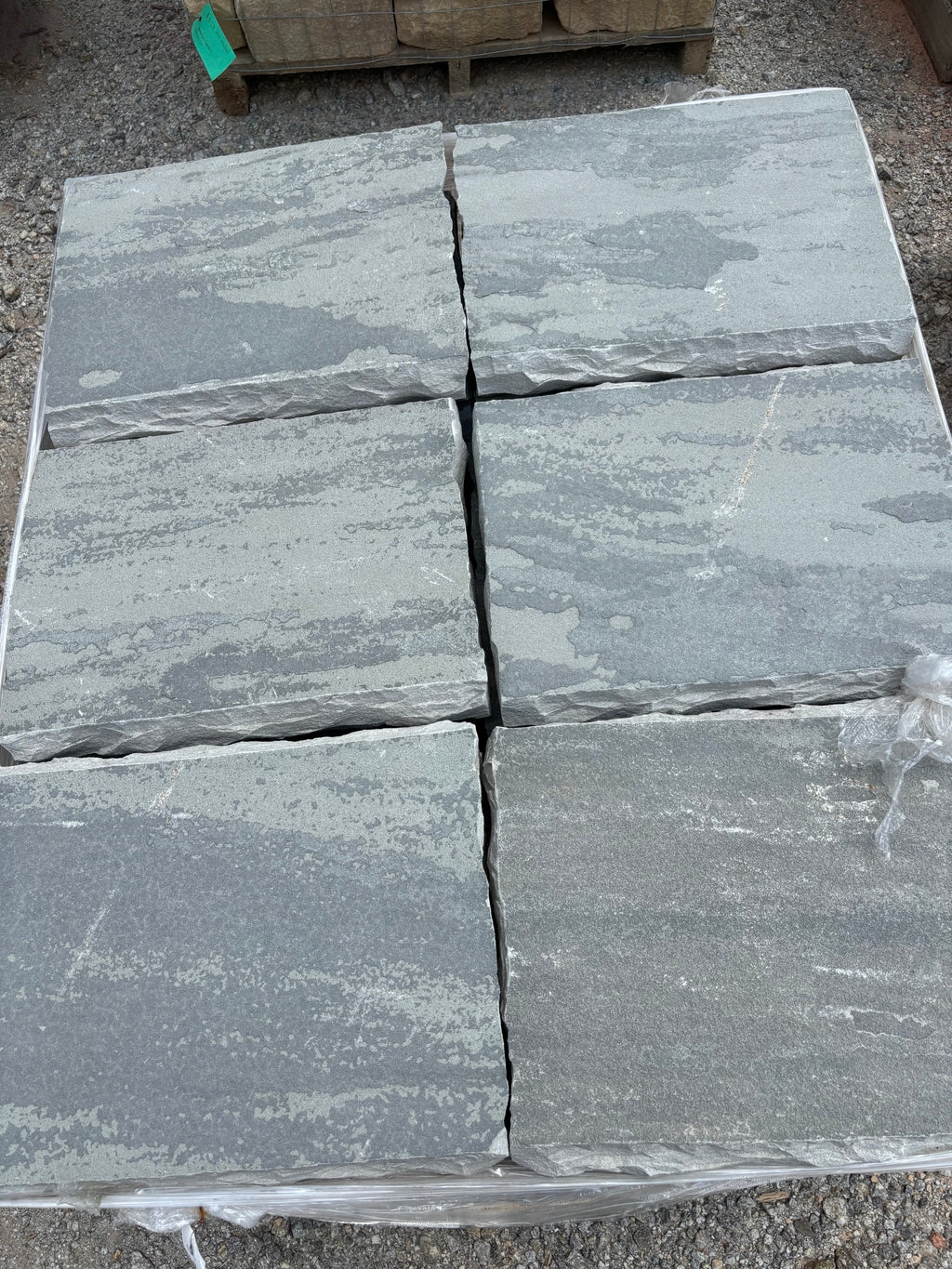 Gray 18 by 24 chiseled stone steppers stacked at 9 Oak in Jenkinsburg Georgia