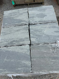 Gray 18 by 24 chiseled stone steppers stacked at 9 Oak in Jenkinsburg Georgia